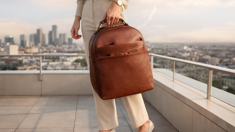 Von Baer Liberty luxury women’s brown full-grain Italian leather backpack with model on a New York rooftop.