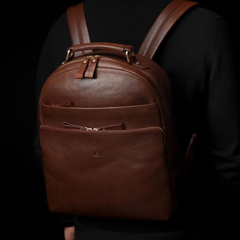 Von Baer Liberty stylish women's full-grain leather backpack in brown, worn by a male model