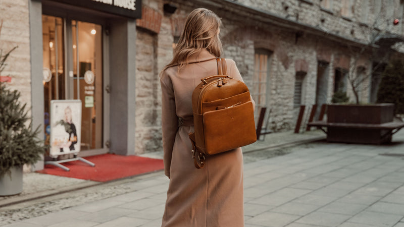 Von Baer Liberty stylish women's full-grain leather backpack in tan, worn by a woman in a beige coat (slider)