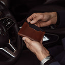 von baer luxury element leather card case wallet solid brown in the hands of businessman