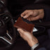von baer luxury element leather card case wallet solid brown in the hands of businessman