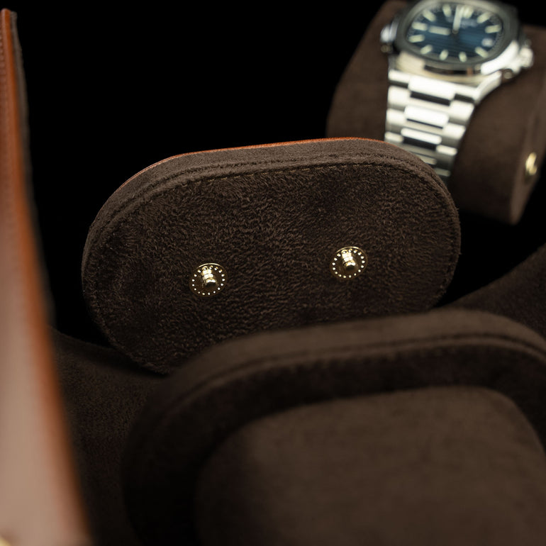 An inside view of a brown Von Baer luxury leather watch roll, showing the smooth suede lining.