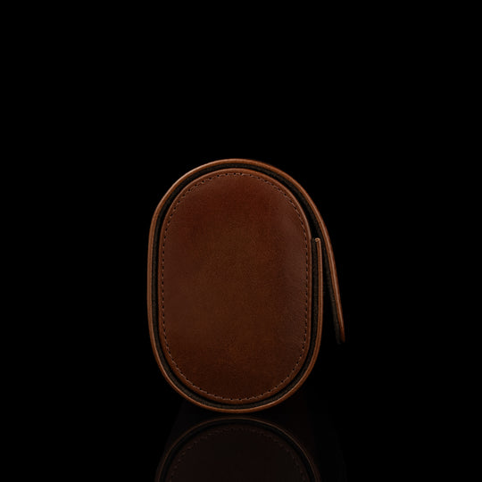 A side view of a brown Von Baer luxury leather watch roll.