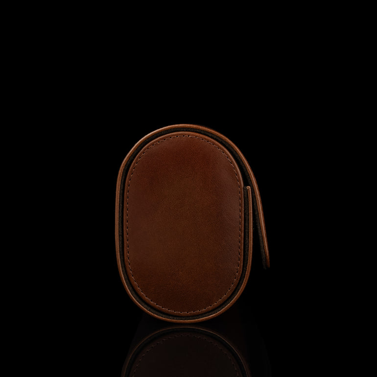 A side view of a brown Von Baer luxury leather watch roll.