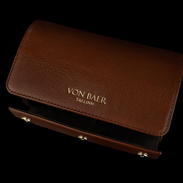 An upper view of a brown Von Baer luxury leather watch roll.