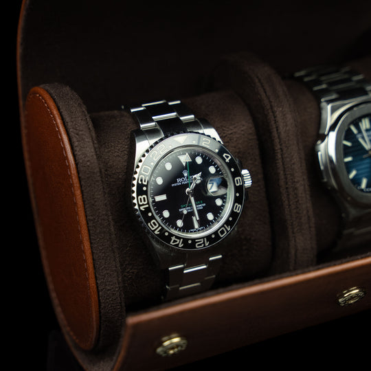 A close-up of a brown Von Baer luxury leather watch roll with a Rolex watch inside, a perfect gift idea.