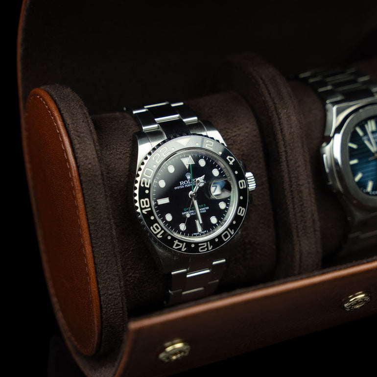 A close-up of a brown Von Baer luxury leather watch roll with a Rolex watch inside, a perfect gift idea.