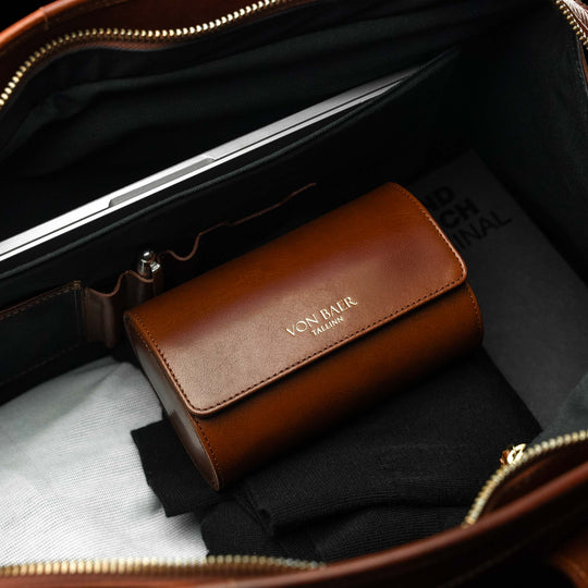 A Von Baer luxury leather watch roll inside a weekender bag.