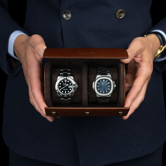 A brown Von Baer luxury quality full-grain leather watch roll with a Rolex and a Patek Philippe watch.