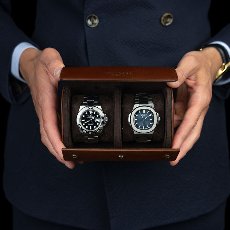 A brown Von Baer luxury quality full-grain leather watch roll with a Rolex and a Patek Philippe watch.