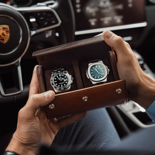 A brown Von Baer luxury quality leather watch roll with a Rolex watch inside, sitting in a Porsche car.