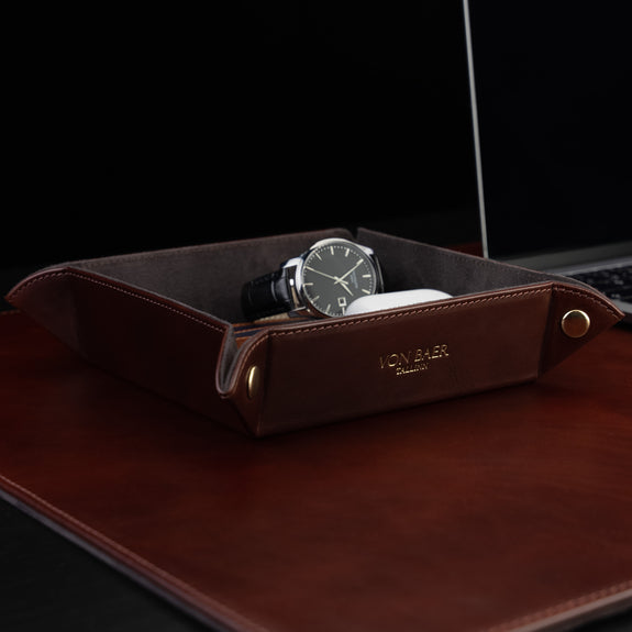 Von Baer Majestic luxury Italian leather tray desk organizer, catch-all in brown, placed on a leather desk pad and filled with office essentials.