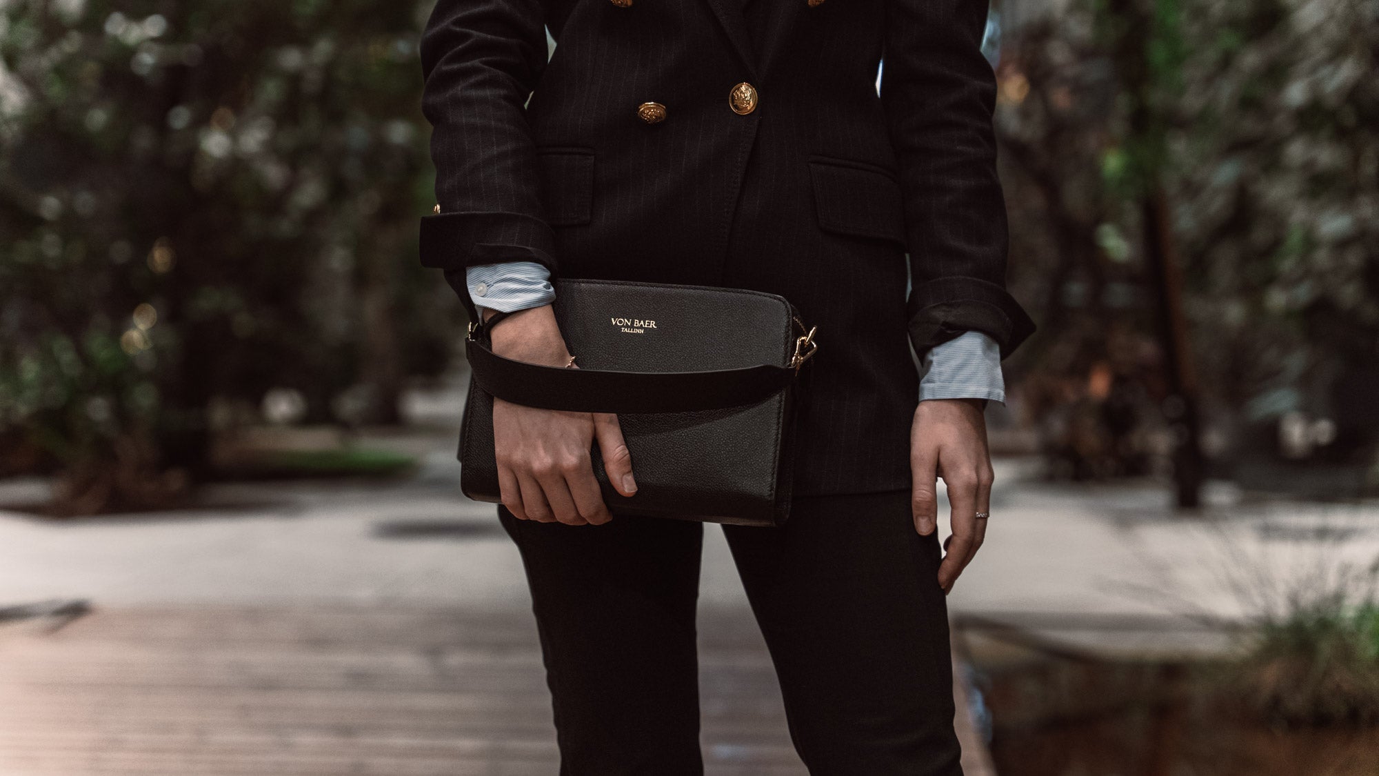 von baer model 1 womens small leather handbag black with removable handle female model holds in hand slider