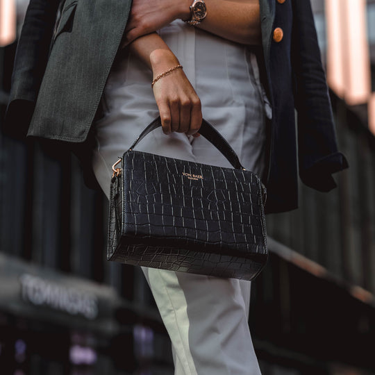 Von Baer Model1 small luxury leather purse in croco style close-up in hands of female model