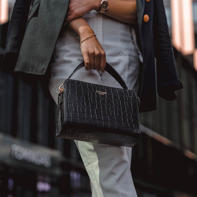 Von Baer Model1 small luxury leather purse in croco style close-up in hands of female model