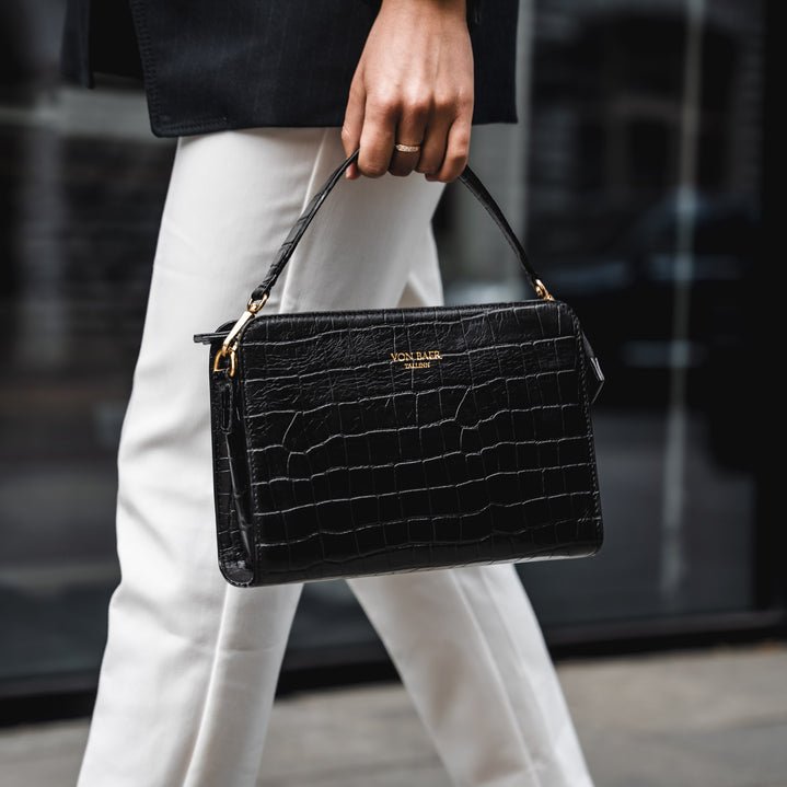 Von Baer Model1 small luxury leather purse in croco style close-up in hands