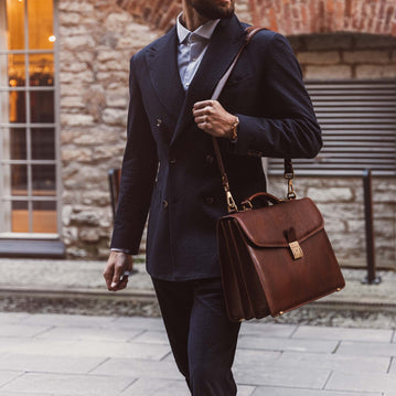 briefcase shown carried by the shoulder strap by male model