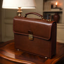 Von Baer No.3 luxurious compact full-grain leather briefcase for men in a classic luxury office with vintage lamp interior.
