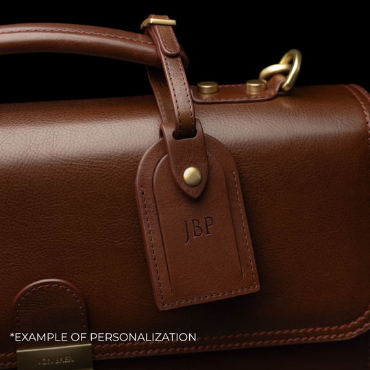 Von Baer No.3 men’s compact full-grain leather briefcase luggage tag close-up with personalized embossed initials.