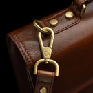 Von Baer No.3 men’s compact full-grain leather briefcase VB logo metal hardware close-up showing premium brand detail.