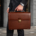 Von Baer No.3 men’s classic compact full-grain leather briefcase in brown, city setting for businessman and professional work.