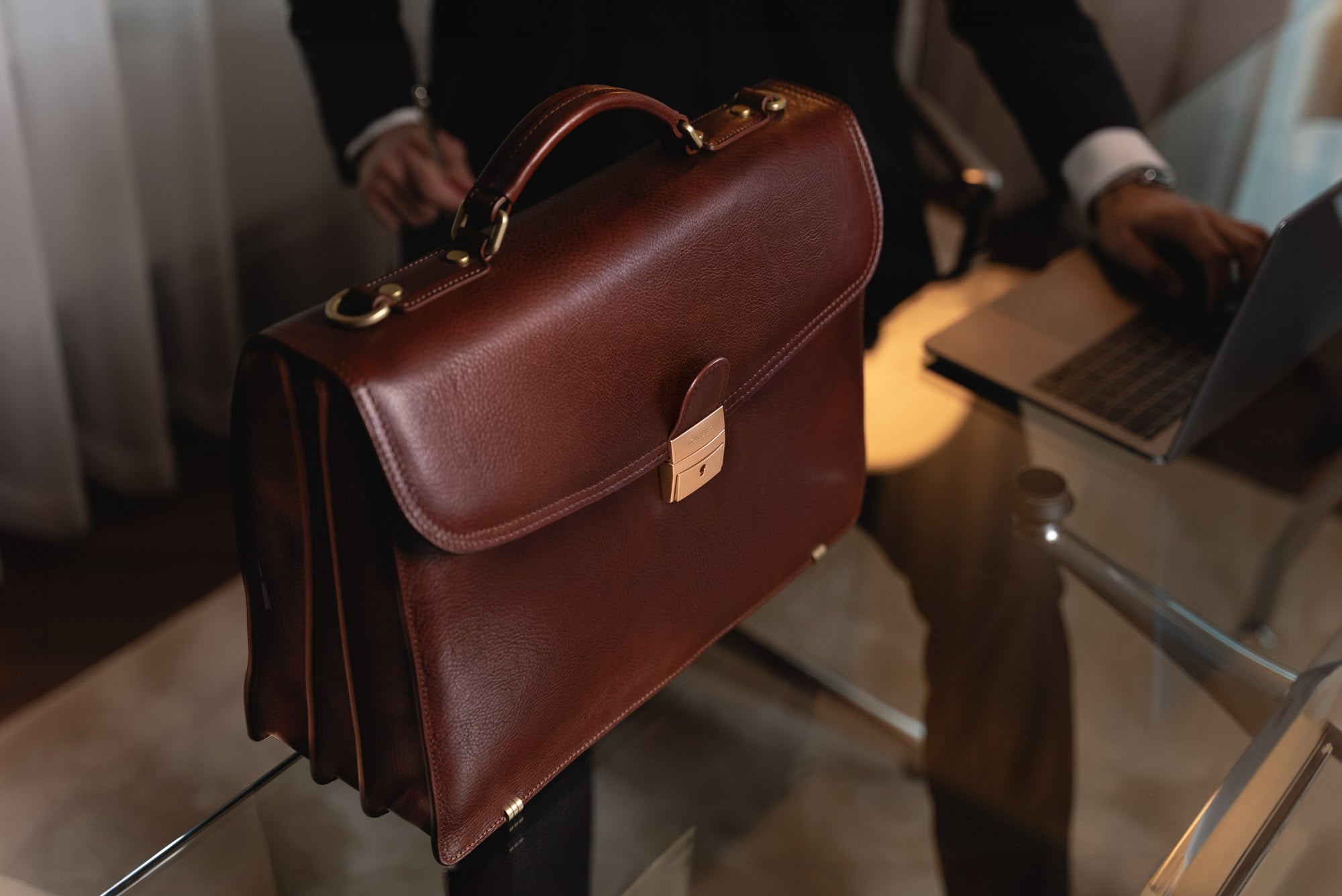 Von Baer No.1 luxury men’s leather briefcase in brown on a table, large work bag for documents and laptop.