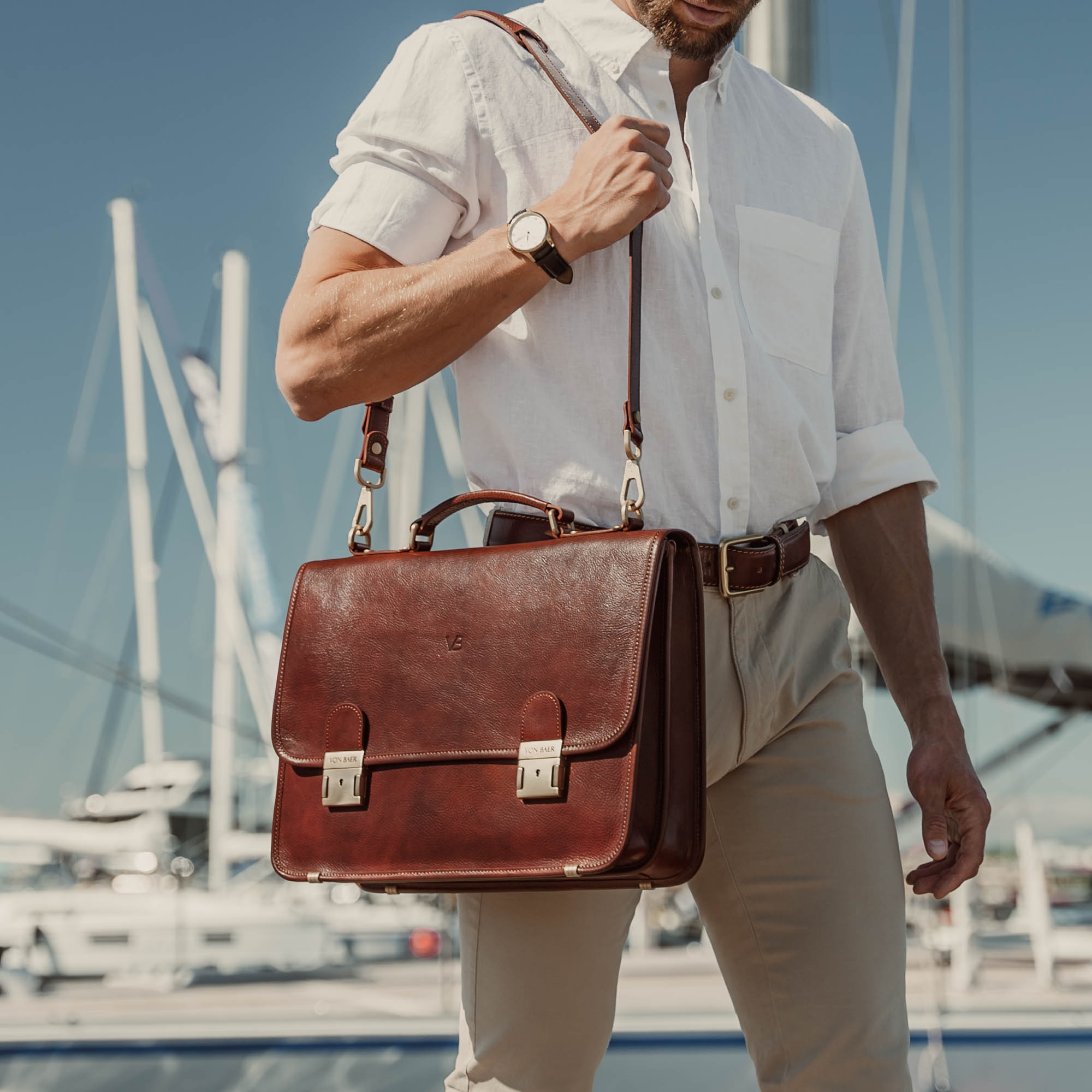 von baer no2 luxury leather messenger briefcase brown with shoulder strap carried by businessman in harbour