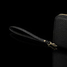 Von Baer origin luxury RFID men’s leather wallet in cognac tan with wrist strap, close-up showing premium detail.