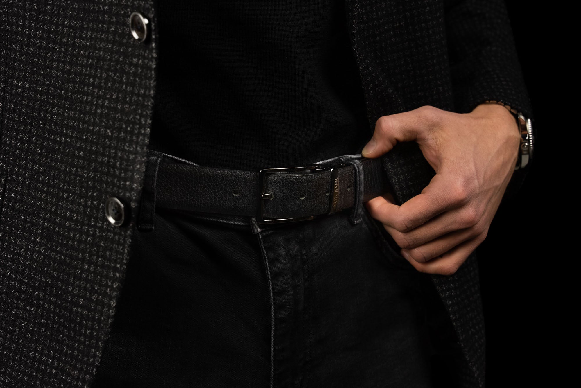 Von Baer Premier luxury reversible natural leather belt for men, featuring the black side, worn by a male model