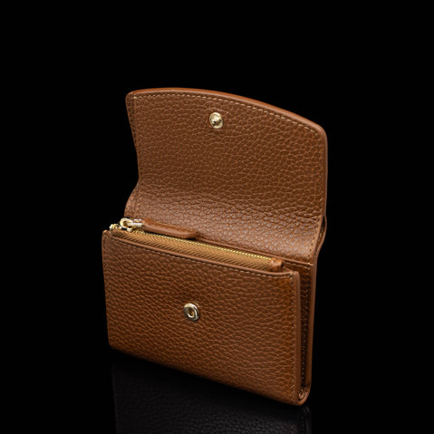 Von Baer Reverie compact cognac pebbled  compact leather wallet for women, shown open against a black background, featuring a gold-tone zipper and snap-button closure