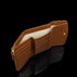 Von Baer Reverie small cognac pebbled leather wallet for women, shown open to reveal card slots, a cream-colored lining, and a banknote compartment with a gold-tone zipper pull against a reflective black background