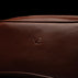 Von Baer Superior durable luxury full-grain leather wash bag in brown, featuring the VB logo close-up.