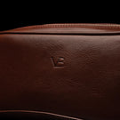 Von Baer superior durable luxury full-grain leather wash bag for women in brown, featuring the Von Baer logo close-up.