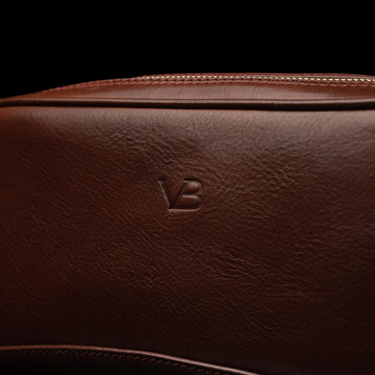 Von Baer superior durable luxury full-grain leather wash bag for women in brown, featuring the Von Baer logo close-up.