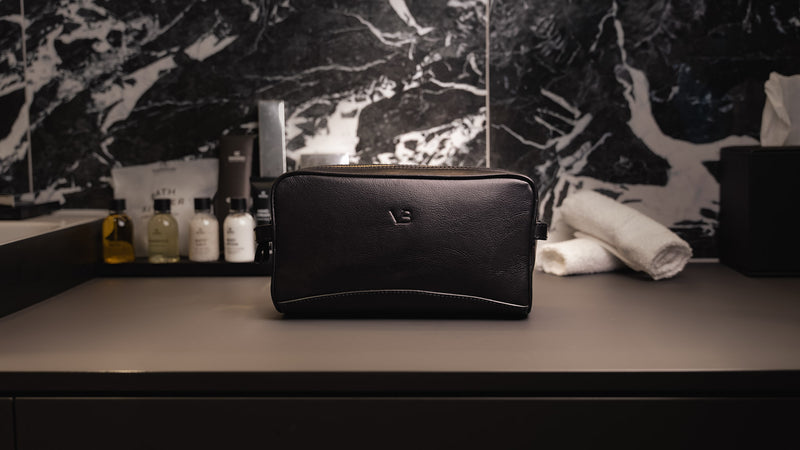 Von Baer superior high-quality luxury full-grain leather wash bag in black, placed in an expensive bathroom – slider