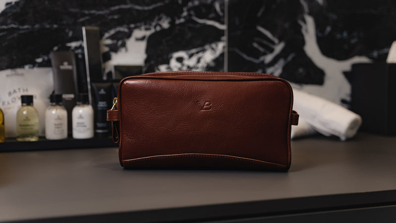 Von Baer superior high-quality luxury full-grain leather wash bag in brown, placed in the elegant bathroom – slider.
