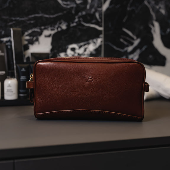 Von Baer superior high-quality luxury full-grain leather wash bag in brown, placed in the elegant bathroom.