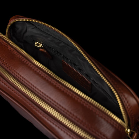 Von Baer superior luxury full grain leather wash bag in brown with a zipped pocket, ideal for travel and daily use.