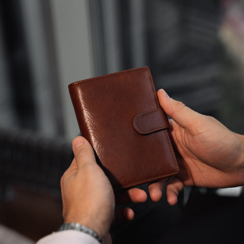 Von Baer Tallinn heritage large men's high-quality leather trifold wallet in the hands of a male model in luxury apartments.