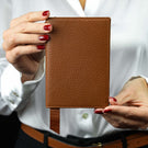Von Baer Avia luxury leather passport holder held in a woman’s hands
