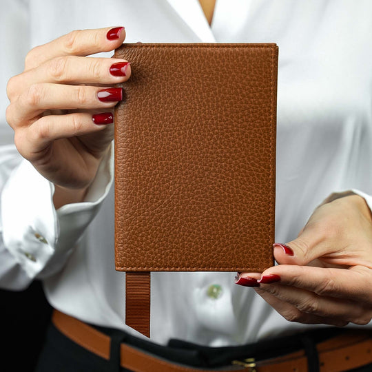 Von Baer Avia luxury leather passport holder held in a woman’s hands