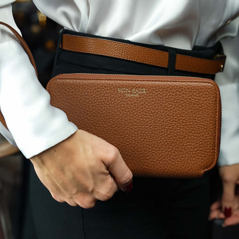 Von Baer W2 luxury large leather purse with wrist strap held by a female model