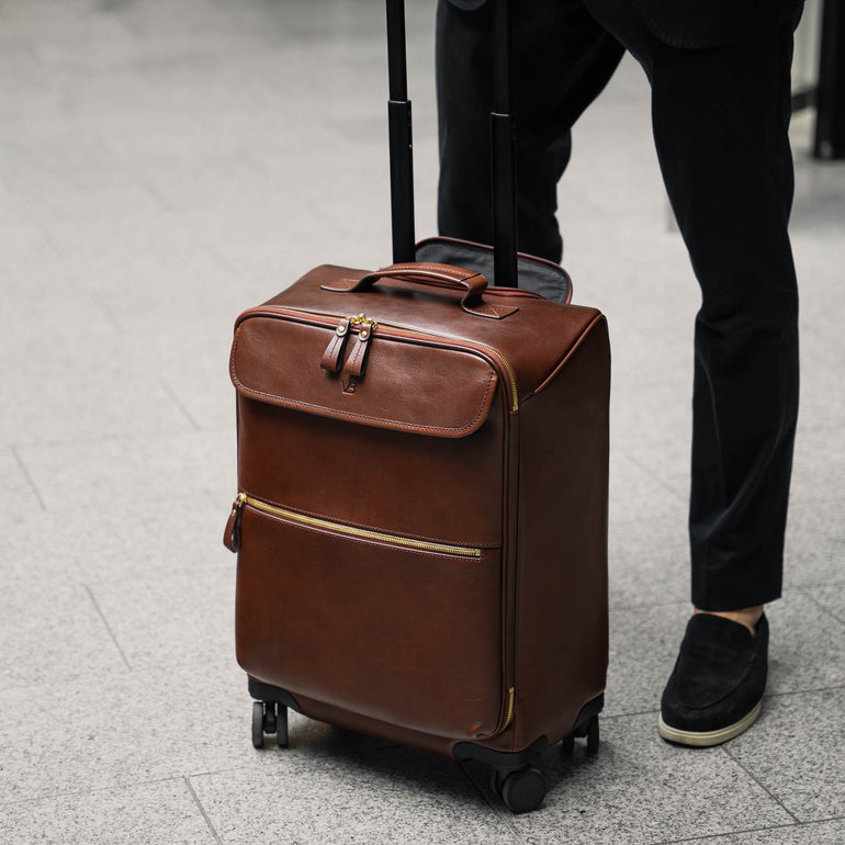 Von Baer Voyager luxury carry-on trolley bag in airport with male model