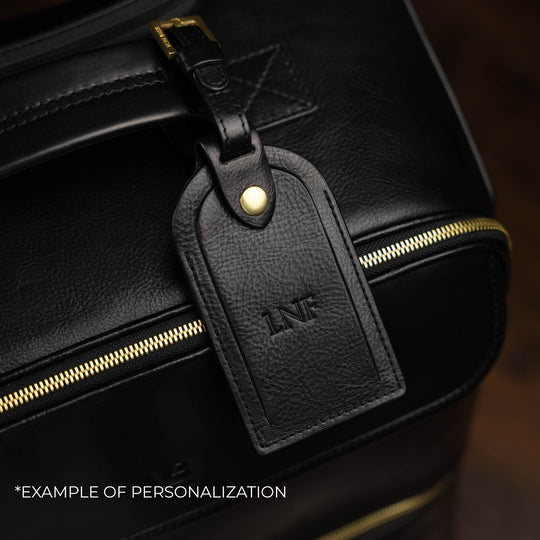Von Baer Voyager luxury black leather carry-on trolley bag with personalized embossed initials on luggage tag