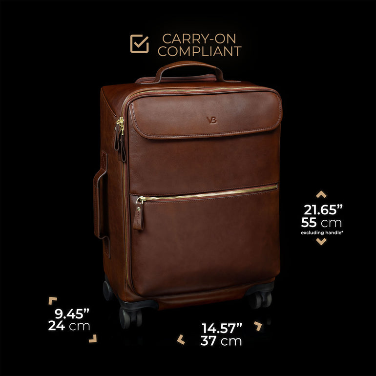 Brown leather suitcase with dimensions and 'carry-on compliant' label on a black background