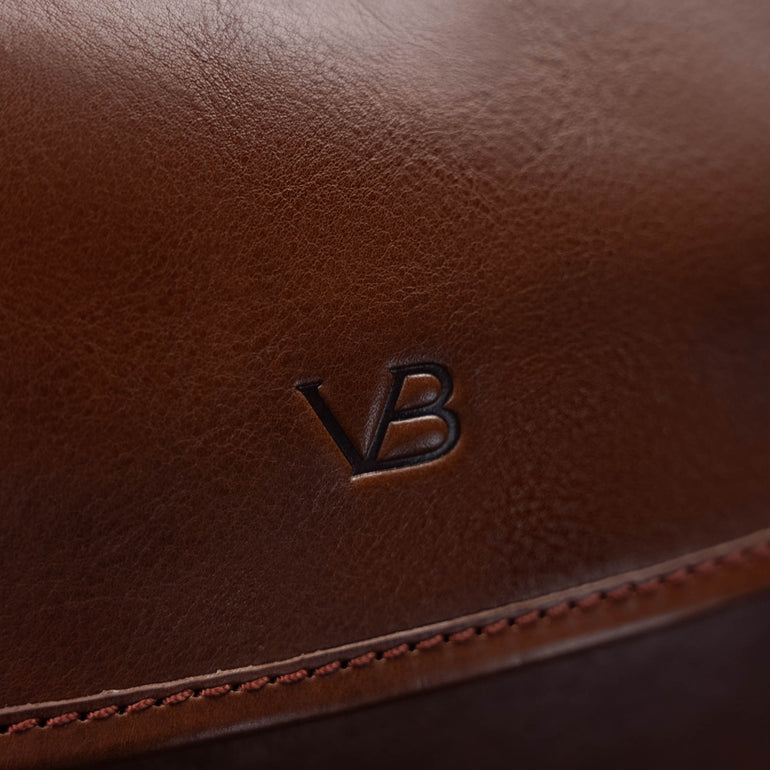 Von Baer Voyager luxury brown leather carry-on trolley bag for travel close-up of VB logo