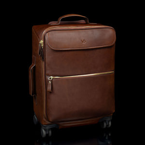 Brown Von Baer Voyager women's luxury leather carry on trolley bag for travel on black background