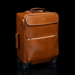 Tan Von Baer Voyager women's luxury leather carry on trolley bag for travel on black background