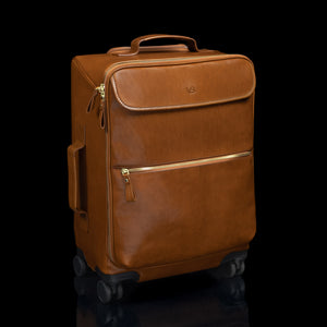 Tan Von Baer Voyager women's luxury leather carry on trolley bag for travel on black background