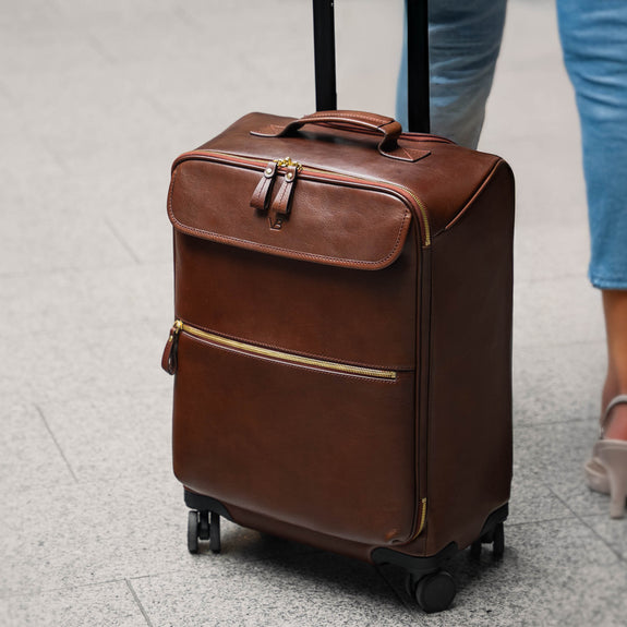 Female model with Von Baer Voyager luxury leather carry on bag at airport
